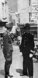 German army officer talking to a policeman in British uniform, St Helier, Jersey. The Channel Islands, part of Great Britain,