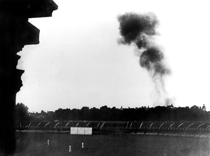 Smoke from a doodlebug rises over Lord’s during a wartime match.