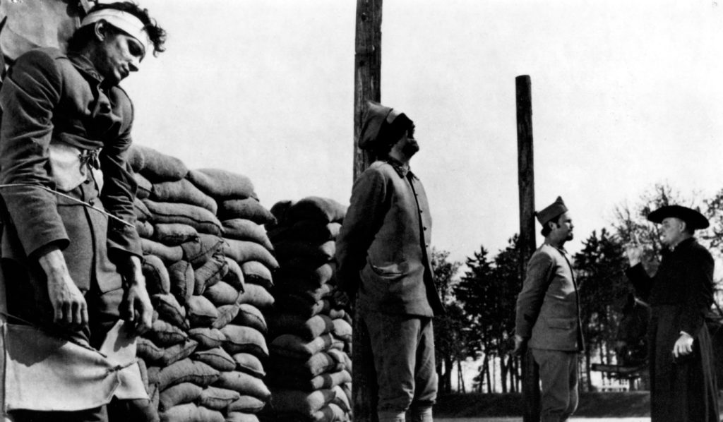 The three men are lined up before the firing squad. When the shots are fired, Kubrick made sure the camera filmed straight on, facing the men, so that the finality and injustice of the execution were unavoidable for the viewer. 