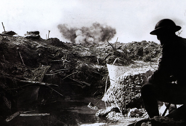A British soldier lies low in a captured German emplacement.