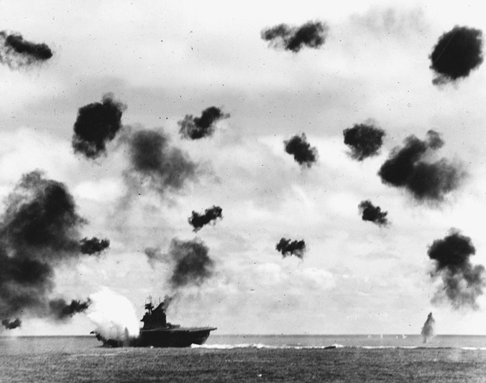 USS Yorktown was the target of two Japanese air-strikes. It is seen here at the moment of a torpedo impact.