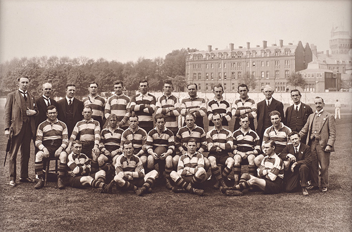 A team photograph of the 1920-21 Cardiff RFC squad. Lewis is seated in the middle row, holding the ball.